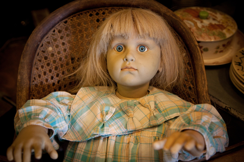 Creepy blonde doll in chair